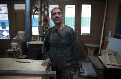 In this Tuesday, Jan. 22, 2019 photo, carpenter Mohammad Reza Tajik is interviewed by The Associated Press about Iran's 1979 Islamic Revolution at his workshop, in northern Tehran, Iran. Forty years after he defected from the shahâ€™s Imperial Guard to join the Islamic Revolution, Tajik, like many Iranians from that time, looks back wistfully at the youthful excitement they felt and the losses they suffered since then. (AP Photo/Vahid Salemi)