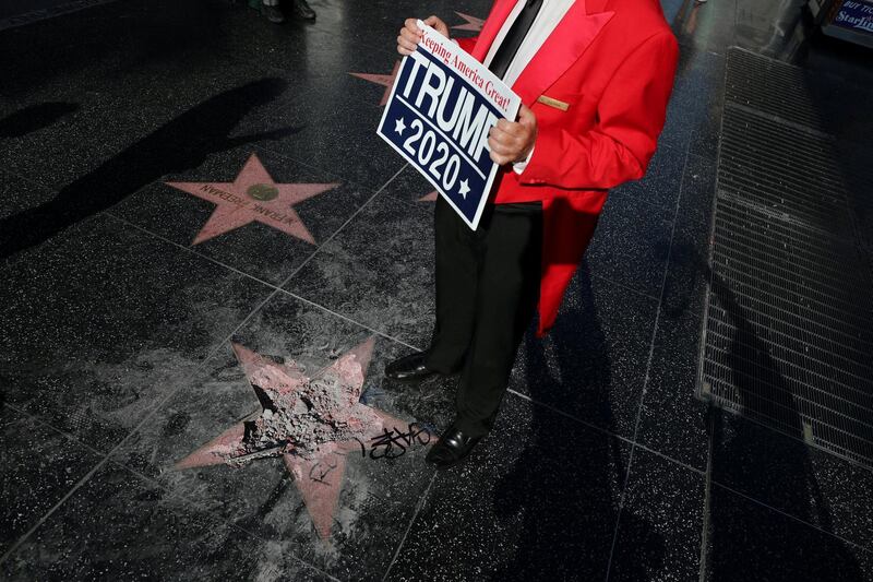 Greg Donovan stands on President Donald Trump's vandalized star on the Hollywood Walk of Fame in Hollywood, Los Angeles, California. Lucy Nicholson/Reuters