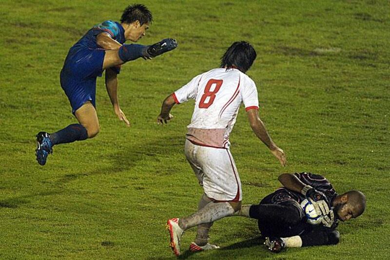 The UAE goalkeeper Ali Khasif was kept busy during the night, as he collects a long ball on a tricky night for custodians.

Manan Vatsyayana / AFP