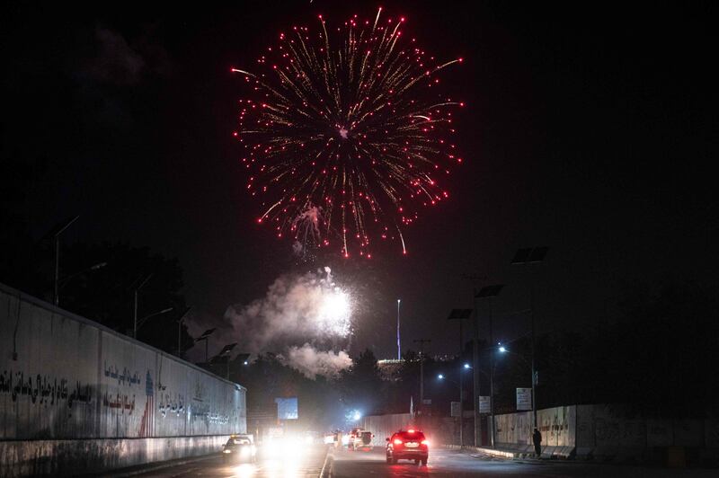 Taliban fighters set off fireworks near the former US embassy in Kabul to celebrate the anniversary. AFP