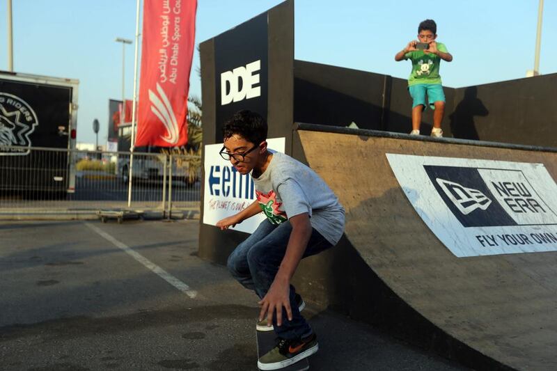 Diab Fahim, 13, uses a ramp set up at the Abu Dhabi International Show to perform a few tricks while his friend Jason Iliovits, 13, films  the trick in Abu Dhabi. Sammy Dallal / The National