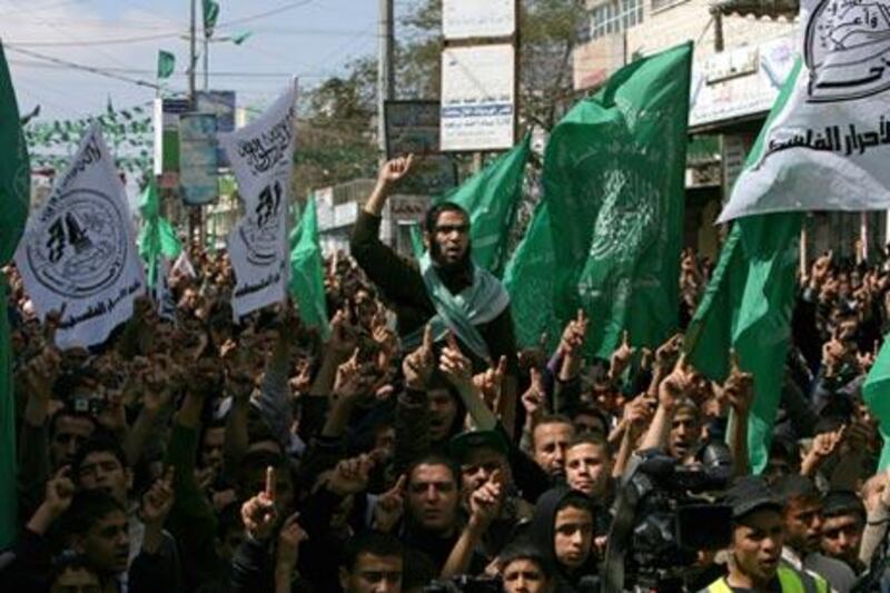 Palestinian supporters of Gaza's ruling Hamas government shout slogans and wave their party's green flags during a protest in Rafah today.