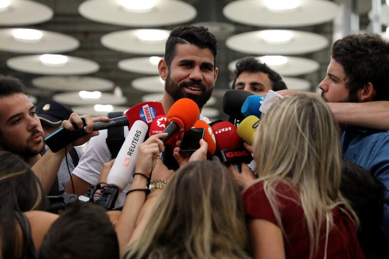 Spain's soccer player Diego Costa speaks to media upon arriving at Adolfo Suarez Madrid Barajas airport in Madrid, Spain, September 22, 2017. REUTERS/Sergio Perez