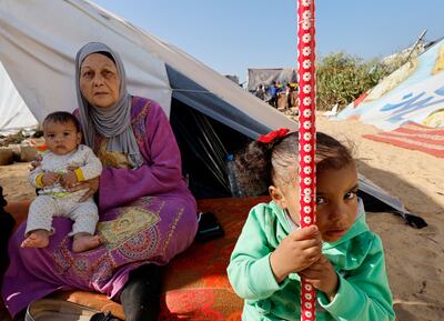 A Palestinian family who fled their homes due to Israeli strikes. Reuters
