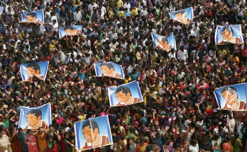 A gathering of school children hold up posters with Tendulkar's image in Chennai, India on Thursday. Arun Sankar K / AP