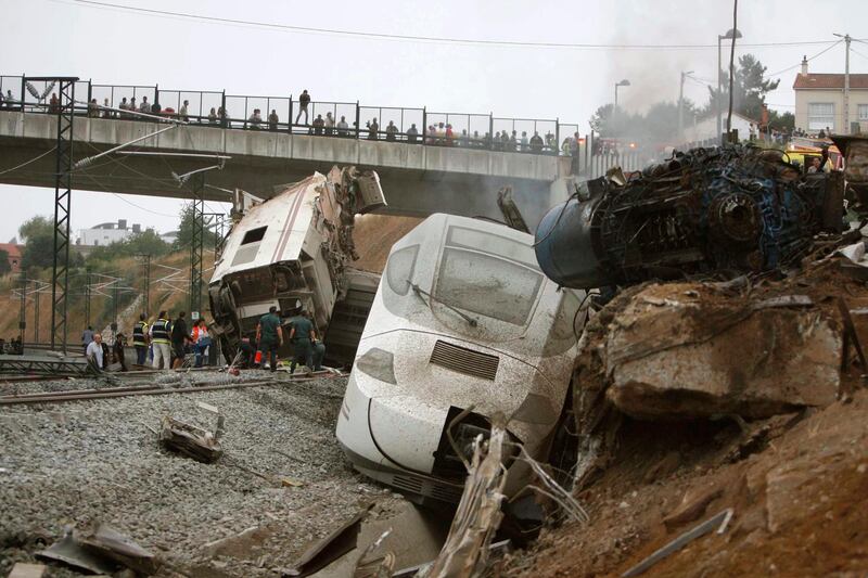 Emergency personnel respond to the scene of a train derailment in Santiago de Compostela, Spain, on Wednesday, July 24, 2013. A train derailed in northwestern Spain on Wednesday night, toppling passenger cars on their sides and leaving at least one torn open as smoke rose into the air. Dozens were feared dead, with possibly even more injured. (AP Photo/ El correo Gallego/Antonio Hernandez) *** Local Caption ***  Spain Train Derailment.JPEG-03cdb.jpg