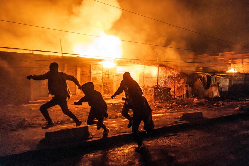 People run from explosions in the Embakasi area of Nairobi. At least two people were reported dead and 222 injured when a lorry carrying gas exploded. AFP