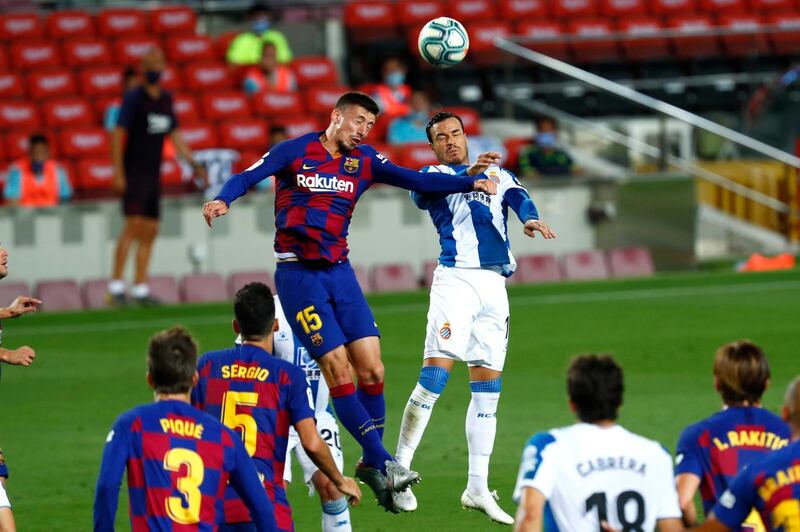 Barcelona's Clement Lenglet jumps for a header against Espanyol's Raul De Tomas. AP Photo