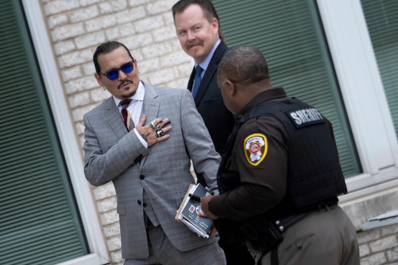 US actor Johnny Depp gestures as he departs the Fairfax County Circuit Court in Fairfax, Virginia. AFP