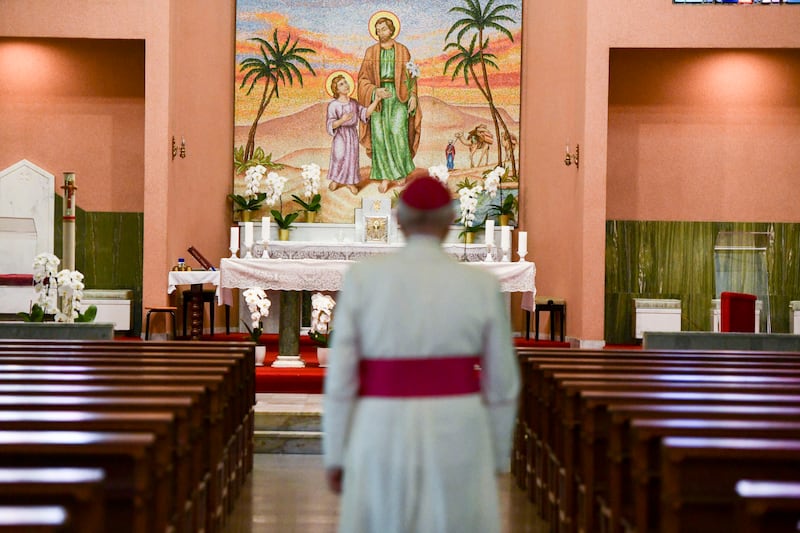 Bishop Paul Hinder walks towards the altar at St Joseph's Cathedral in Abu Dhabi. 