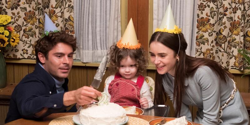 This image released by Netflix shows Zac Efron, left, and Lily Collins, right, in a scene from "Extremely Wicked, Shockingly Evil, and Vile." (Brian Douglas/Netflix via AP)