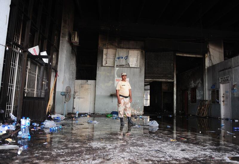 A Pakistani Ranger stands guard at the fire-damaged premises of a cold-storage cargo facility. Rizwan Tabassum/AFP Photo