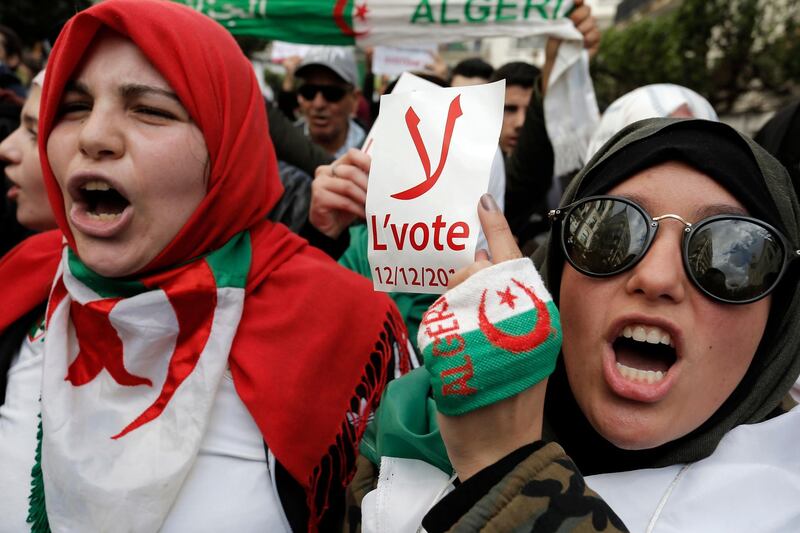An Algerian student holds a poster reading "No to the vote on Dec.12" during a protest in Algiers. AP Photo