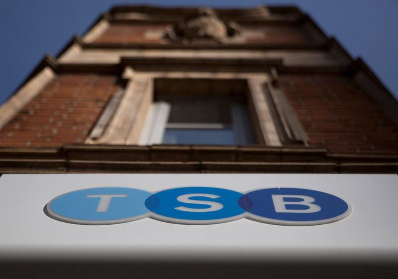 FILE PHOTO: A sign is displayed outside a branch of the TSB bank in central London March 12, 2015. British challenger bank TSB has received a takeover approach from Banco Sabadell, valuing the business at about $2.6 billion and sending its shares soaring by nearly a quarter. REUTERS/Neil Hall/File Photo