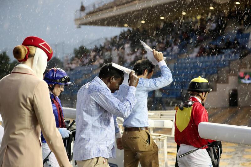 ABU DHABI , UNITED ARAB EMIRATES , November 25  ��� 2018 :- Officials and jockeys during the rain at the Abu Dhabi Equestrian Club in Abu Dhabi. ( Pawan Singh / The National ) For News/Instagram 