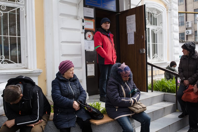 Local residents wait in line to receive humanitarian aid from the International Committee of the Red Cross in the Mykolaiv area of Ukraine. Getty Images