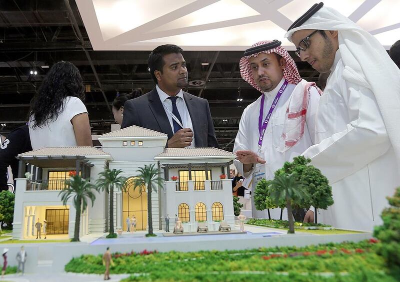 Guests view models of villas of the Mohammed Bin Rashid Al Maktoum City project of Meydan at the Cityscape Global 2014. Satish Kumar / The National