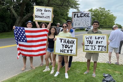 Demonstrators hold signs outside a fundraiser for US President Joe Biden in East Hampton, New York. Bloomberg
