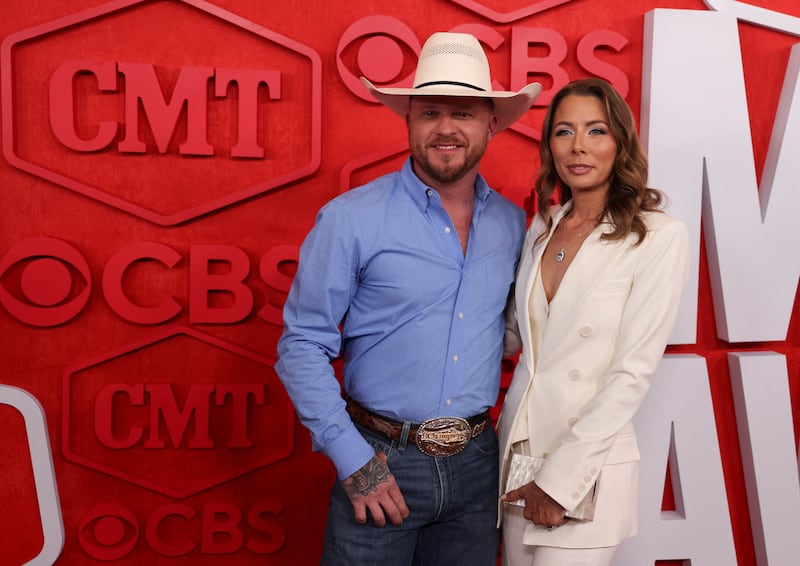 Cody Johnson goes for classic cowboy as he poses with Brandi Johnson on the red carpet. Reuters