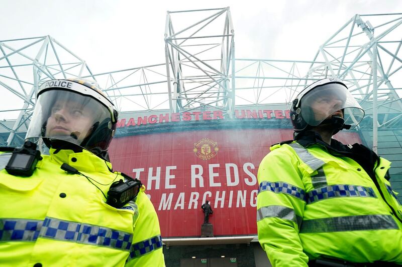 Police officers stand guard as United fans protest against the Glazer family. AP