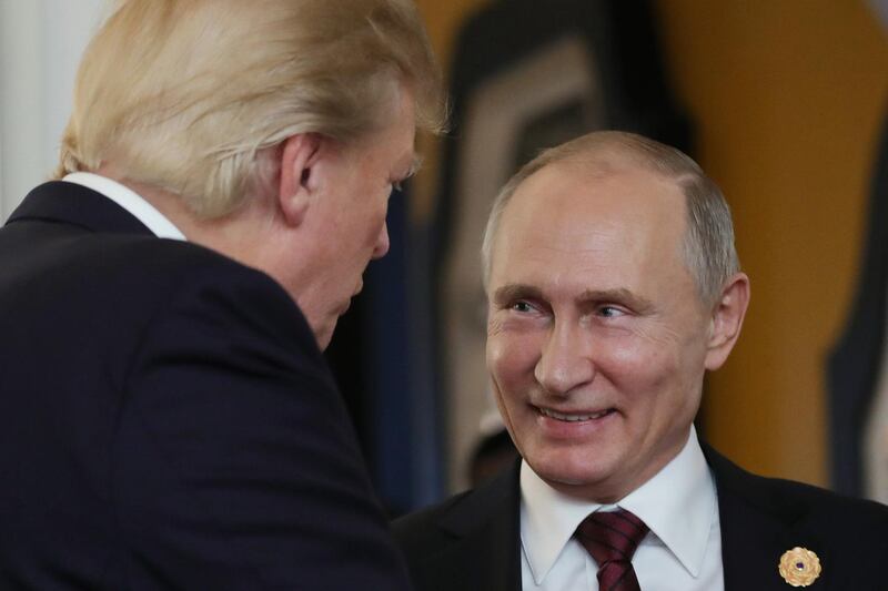 (FILES) In this file photo taken on November 11, 2017 US President Donald Trump (L) chats with Russia's President Vladimir Putin as they attend the APEC Economic Leaders' Meeting, part of the Asia-Pacific Economic Cooperation (APEC) leaders' summit in the central Vietnamese city of Danang on November 11, 2017.
resident Donald Trump, hitting out at the probes and congressional hearings into Russian election meddling, said on February 18, 2018 Moscow is succeeding beyond its "wildest dreams" if its intention is to sow discord within the United States."They are laughing their asses off in Moscow. Get smart America!" Trump said in an early morning tweet.It was one of a series of tweets posted by Trump in the wake of the indictments filed Friday by special counsel Robert Mueller against 13 Russians for meddling in the 2016 US presidential election. / AFP PHOTO / SPUTNIK / Mikhail KLIMENTYEV