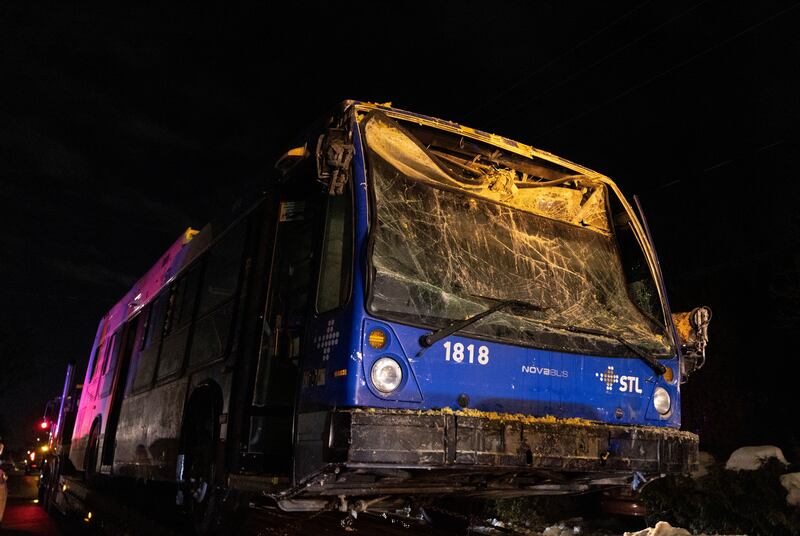 A bus is towed away after being pulled out of the nursery it crashed into in Montreal, Canada, on February 8.
