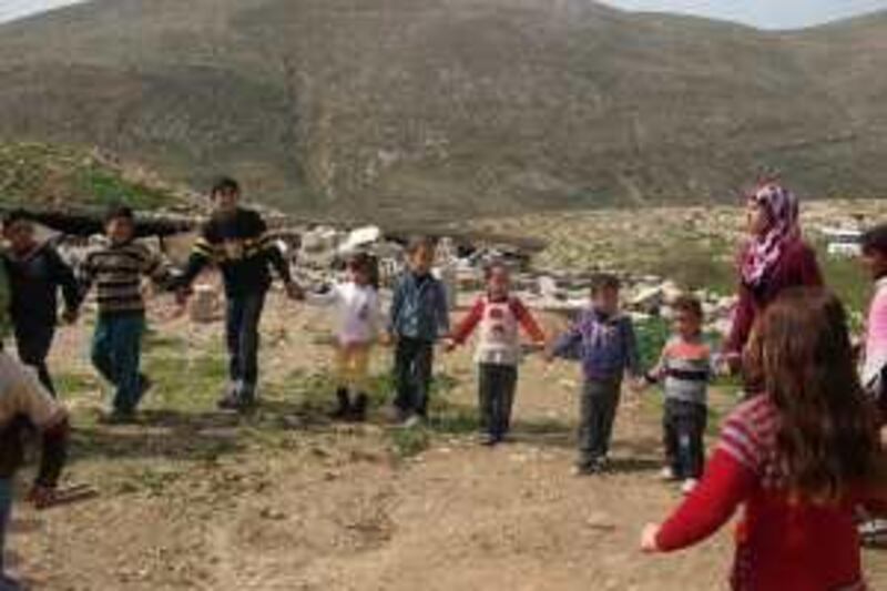 A group of young Palestinian children, some of whom saw their homes being destroyed by Israeli forces last month, are encouraged to relax, laugh and play by a team of UNICEF psycho-social workers at Khirbet Tana.