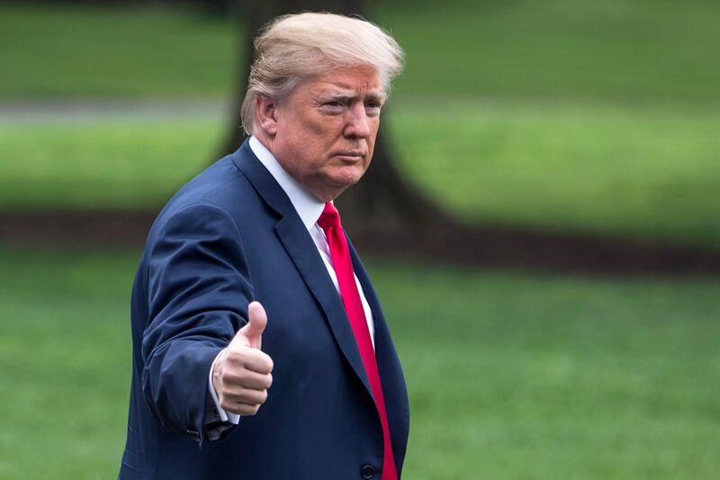 epa06713070 US President Donald J. Trump gestures as he walks towards the 'Marine One' helicopter waiting on the South Lawn of The White House in Washington, DC, USA, 05 May 2018. President Trump was scheduled to travel to Cleveland, Ohio, to speak at Public Hall ahead of state primary elections.  EPA/ZACH GIBSON AFP OUT