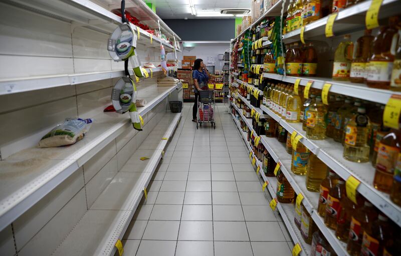 A packet of rice is pictured on an empty shelf as people stock up on food supplies, after Singapore raised coronavirus outbreak alert level to orange, at a supermarket in Singapore February 8, 2020. REUTERS/Edgar Su