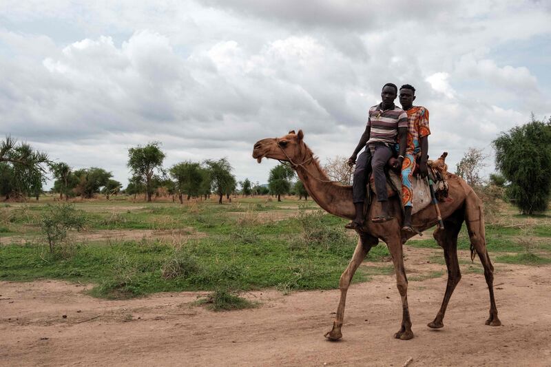Men ride a camel in South Kordofan state. UN High Commissioner for Refugees Filippo Grandi says more food and aid is needed to help people 'that otherwise risk starvation'.