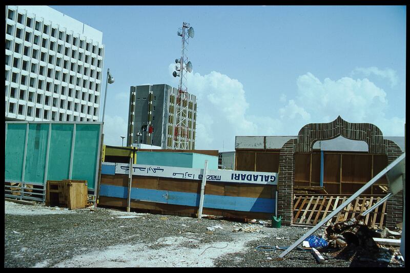 Photograph of salvaged building supplies, by Mark Harris in 1977, define and secure a construction site in Deira