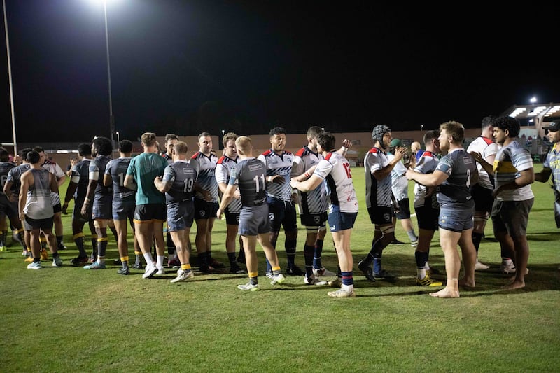 Jebel Ali Dragons and Dubai Hurricanes players shake hands at the end of the UAE Premiership final.