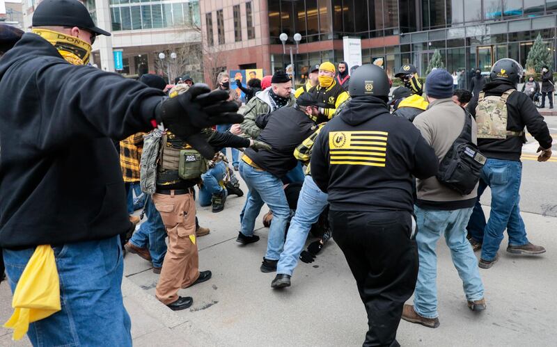 Members of the Proud Boys fight with a counter protester during a rally  at the Ohio Statehouse in Columbus, Ohio. Hundreds of supporters of President Donald Trump, including members of the Proud Boys, a far-right, male-only political organization, came to the Statehouse to protest the congressional certification of Democratic president-elect Joe Biden. AP