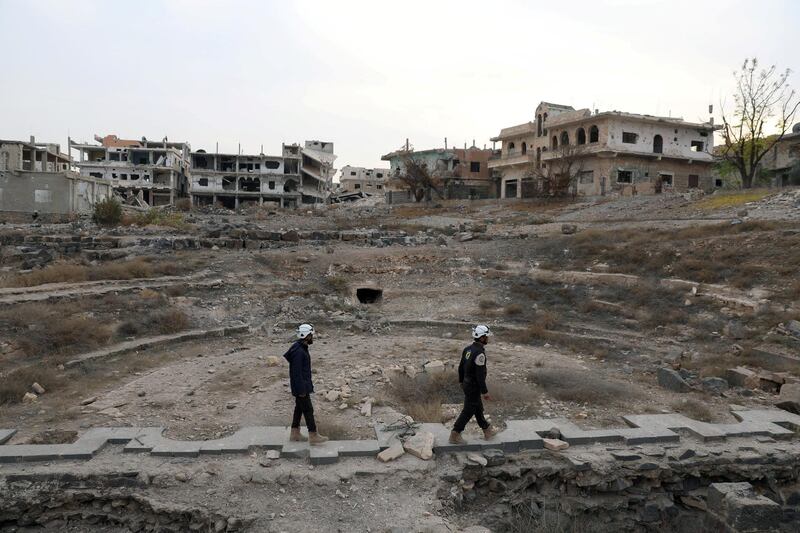 FILE PHOTO: Members of Syria Civil Defence, also known as the 'White Helmets', are seen inspecting the damage at a Roman ruin site in Daraa, Syria December 23, 2017. REUTERS/Alaa al-Faqir/File Photo