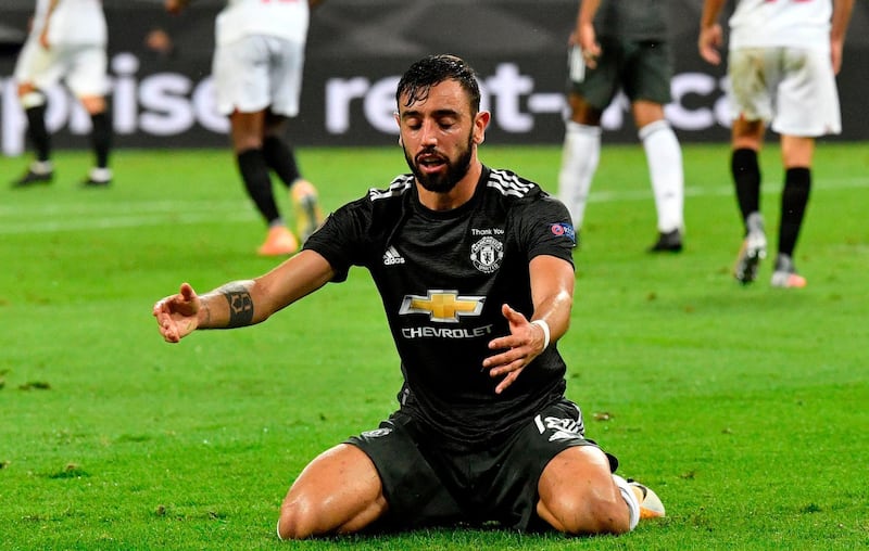 Manchester United's Portuguese midfielder Bruno Fernandes goes down after a challenge. AFP