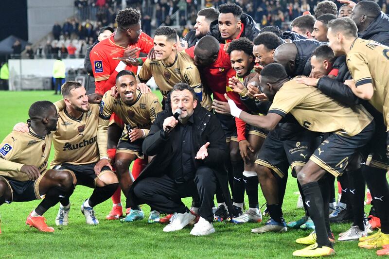 Lens players celebrate with head coach Franck Haise. PSG lost for the first time in any competition since March 20 last year when they were defeated 3-1 at Lens. AFP