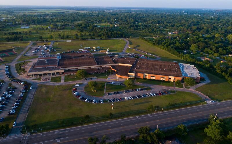Cars still sit in the parking lot where they were left as the sun sets on Santa Fe High School, the scene of a deadly shooting on Friday with multiple fatalities, mostly students, in Santa Fe, Texas. Mark Mulligan / AP Photo