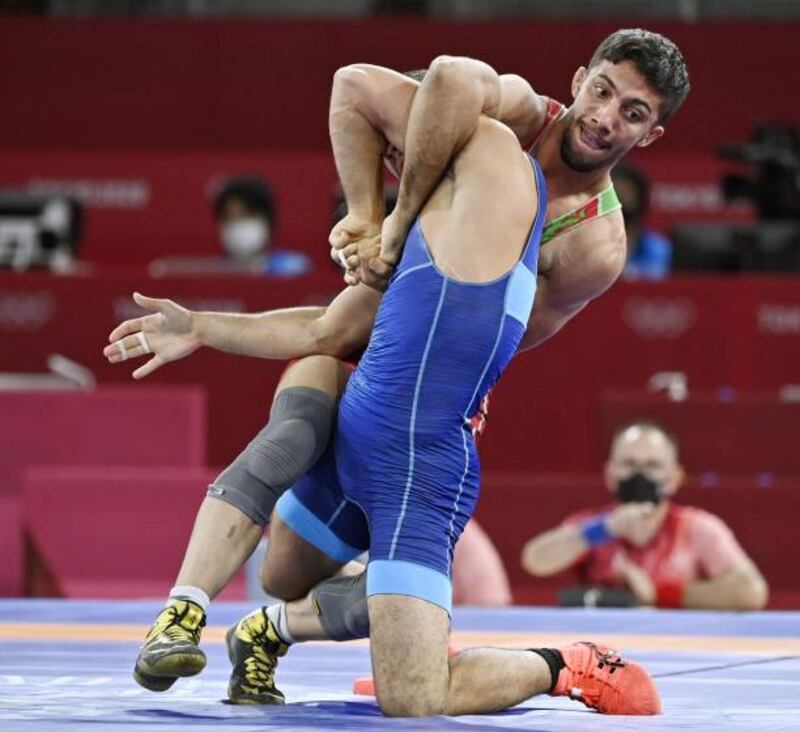 Mohammadreza Geraei of Iran (facing camera) competes en route to winning the Greco-Roman wrestling 67kg final against Ukraine's Parviz Nasibov.