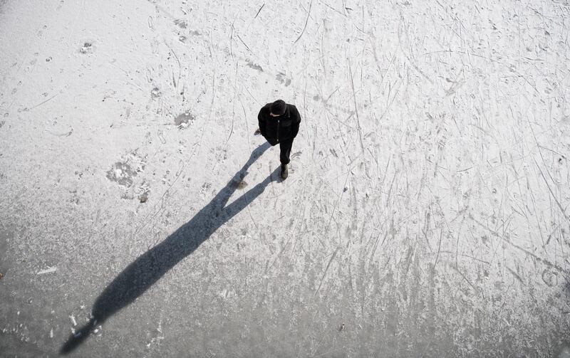 A man walks on frozen Landwehr Canal in the Neukoelln district of Berlin, Germany. Getty