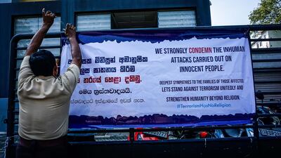 A security guard fixes a sign of solidarity from Muslims to the victims on Sundays bomb attacks, in Colombo, Sri Lanka, April 24, 2019. Jack Moore / The National