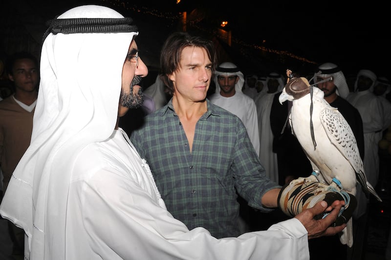 Sheikh Mohammed showed Cruise how to balance a falcon on his arm in November 2010. Photo: Dubai Media Office / AFP