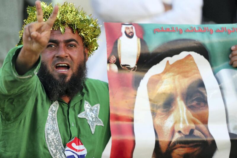 Abu Dhabi, United Arab Emirates - March 04, 2019: A Pakistan fan with a picture of Sheikh Zayed during the match between Peshawar Zalmi and Quetta Gladiators in the Pakistan Super League. Monday the 4th of March 2019 at Zayed Cricket Stadium, Abu Dhabi. Chris Whiteoak / The National