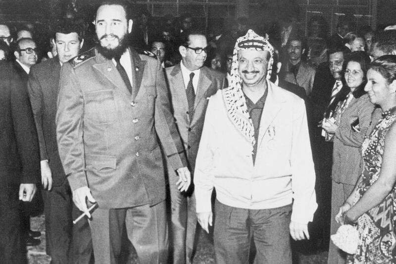 Palestine Liberation Organisation chairman Yasser Arafat walks with Fidel Castro during a visit to Cuba in December 1974. AFP