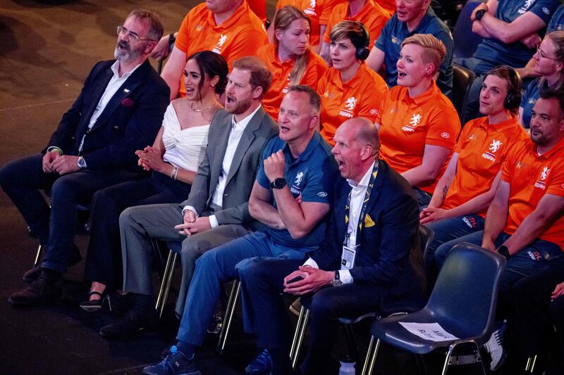 Harry and Meghan cheer the athletes. AFP