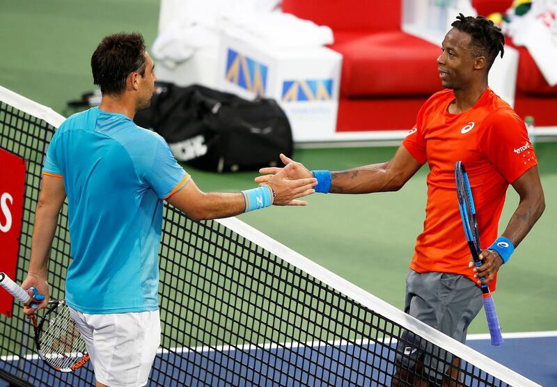 epa07401263 Gael Monfils (R) of France is congratulated by Marcos Baghdatis (L) of Cyprus after winning their second round match at the Dubai Duty Free Tennis ATP Championships 2019 in Dubai, United Arab Emirates, 27 February 2019.  EPA/ALI HAIDER