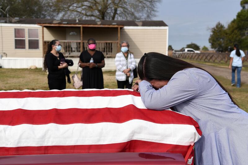 Lila Blanks holds the casket of her husband, Gregory Blanks, 50, who died of Covid-19 in San Felipe, Texas. Reuters