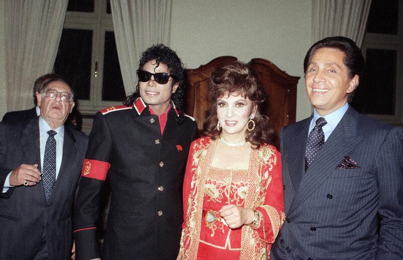 From left, Michael Jackson, Lollobrigida and fashion designer Valentino in 1988. AP