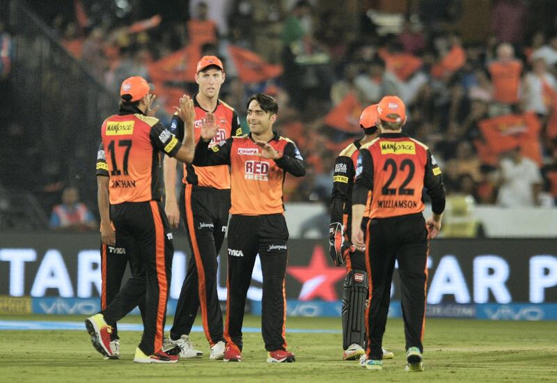 Sunrisers Hyderabad cricketer Rashid Khan (C) celebrates with teammates the wicket of Mumbai Indians Ben Cutting during the 2018 Indian Premier League (IPL) Twenty20 cricket match between Sunrisers Hyderabad and Mumbai Indians at the Rajiv Gandhi International Cricket Stadium in Hyderabad on April 12, 2018. / AFP PHOTO / NOAH SEELAM / ----IMAGE RESTRICTED TO EDITORIAL USE - STRICTLY NO COMMERCIAL USE----- / GETTYOUT