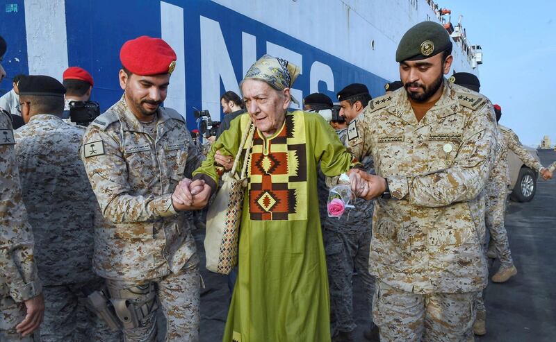 Saudi Navy personnel help civilians. Reuters