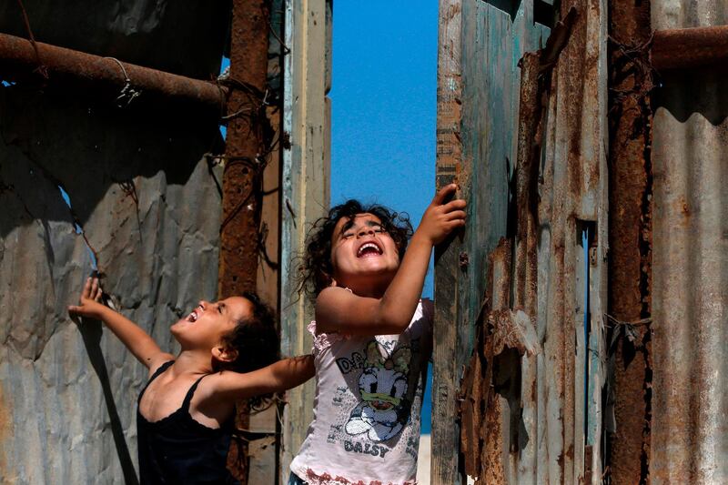 Palestinian children play next to their home in the Gaza Strip's al-Shati refugee camp. AFP